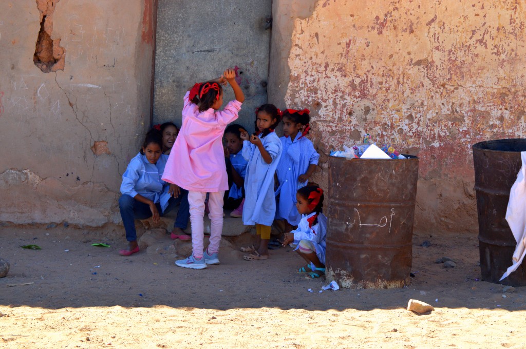 Girls playing during their school break. On the bin someone has written "aman", meaning safety/peacefulness in arabic. 